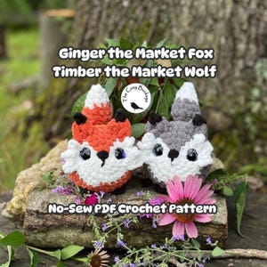 May include: Two plush crochet toys, one orange and white fox and one grey and white wolf, featuring large dark eyes and white chest fur. The text reads Ginger the Market Fox, Timber the Market Wolf, and No-Sew PDF Crochet Pattern.