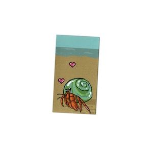 May include: A cartoon illustration of a hermit crab on a beach with two pink hearts. The hermit crab is green and orange and is carrying a shell on its back.