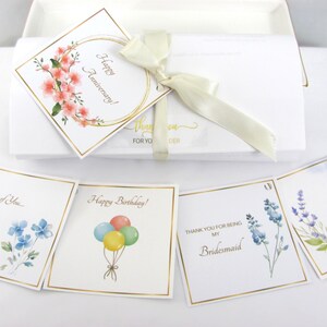 Packaging with ribbon and occasion gift tags.