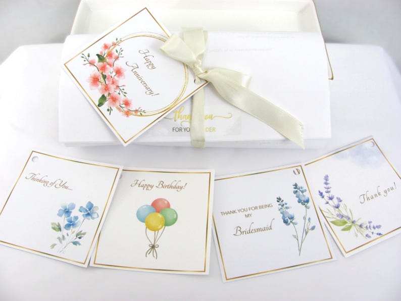 Packaging with ribbon and occasion gift tags.