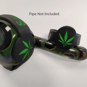May include: Two black silicone wristbands with a green marijuana leaf design. The text "Pipe Not Included" is printed above the wristbands.