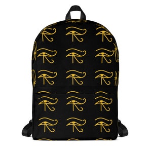 May include: Black backpack with a repeating pattern of gold Egyptian Eye of Horus symbols.