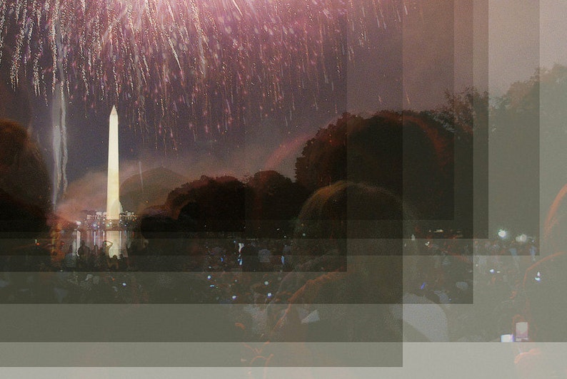 May include: A view of the Washington Monument with fireworks exploding in the sky above. The monument is lit up and reflected in the water below. People are gathered in the foreground, watching the fireworks.