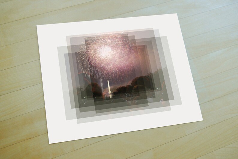 May include: A photograph of fireworks exploding over a city skyline at night. The fireworks are pink, white, and yellow. The city skyline is dark and silhouetted against the night sky.