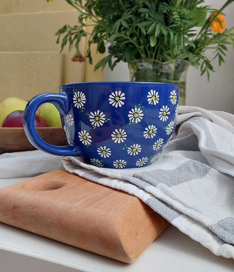 Daisy mug on a wooden cutting board, shown from a different angle