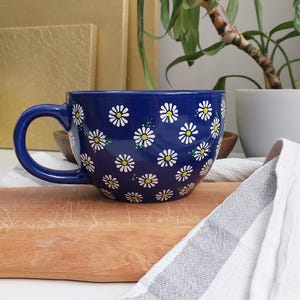 Daisy mug photographed straight on, showing its wide, rounded shape