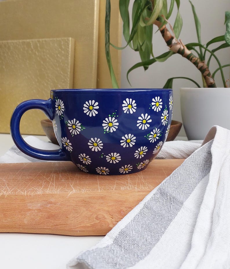 Daisy mug photographed straight on, showing its wide, rounded shape