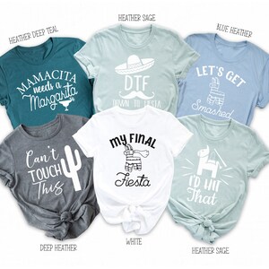 May include: Set of six t-shirts with different designs and colors. The shirts feature phrases like "Mamacita needs a Margarita", "DTF Down to Fiesta", "Let's Get Smashed", "Can't Touch This", "My Final Fiesta", and "I'd Hit That".