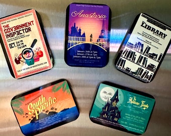 May include: Five rectangular magnets featuring theatrical posters for Rouse High School productions including The Government Inspector, Anastasia, The Library, South Pacific, and The Addams Family, each displaying specific performance dates and show details.