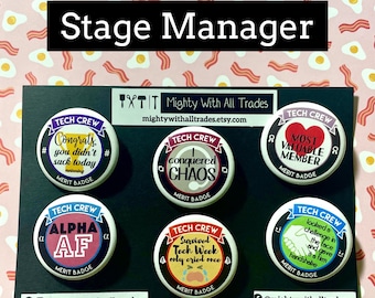 Könnte beinhalten: Sechs runde schwarz-weiße Knöpfe mit bunten Akzenten. Jeder Knopf trägt den Text "Tech Crew" und einen anderen humorvollen Spruch rund um das Thema Bühnenmanagement. Die Sprüche lauten: "Herzlichen Glückwunsch, du hast heute keinen Mist gebaut", "Ich habe das Chaos besiegt", "Wertvollstes Mitglied", "Alpha AF", "Tech-Woche überlebt, nur einmal geweint", und "Habe eine Herausforderung ins Gesicht geschaut und ihr einen festen Händedruck gegeben".