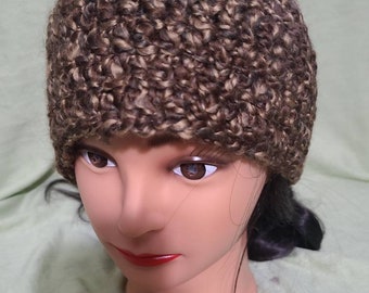 May include: A brown and beige crocheted beanie hat.