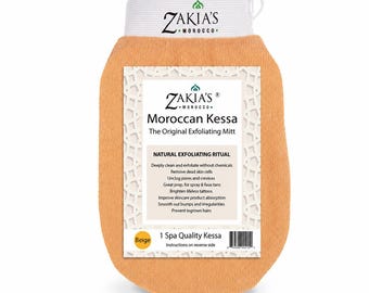 May include: A beige exfoliating mitt with a white wristband featuring the text Zakia's Morocco. The mitt has a label reading Zakia's Morocco, Moroccan Kessa, The Original Exfoliating Mitt, Natural Exfoliating Ritual, and lists benefits like removing dead skin cells.