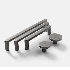 May include: Three black metal cabinet pulls with rounded edges and two matching black metal knobs. The pulls are 12 inches long and the knobs are 1.5 inches in diameter.