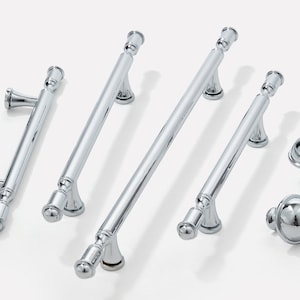 May include: A set of six chrome cabinet hardware pulls and knobs. The pulls are all straight with rounded ends and come in three different lengths. The knobs are round with a dome shape.
