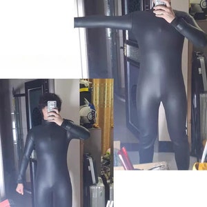 May include: A black wetsuit with long sleeves and a high neck. The wetsuit is made of a smooth, shiny material.