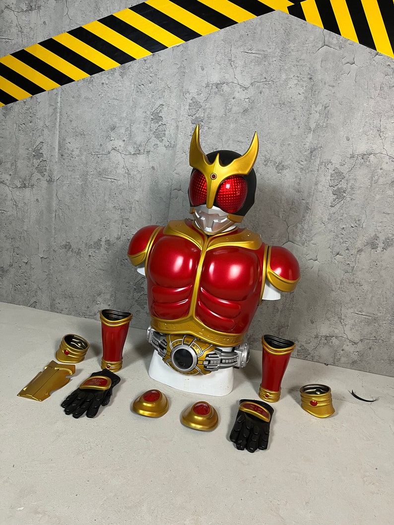 May include: A red and gold plastic action figure costume set. The set includes a torso, two arms, two legs, two gloves, two shoulder pads, a belt, and two wrist cuffs. The figure is a popular character from a Japanese television show.