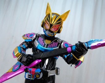 May include: A black and gold action figure wearing a blue and pink suit, holding a pink and blue electric guitar. The figure has a cat-like helmet with red eyes.