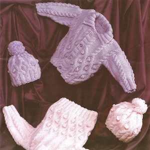 May include: Two knitted baby sweaters and two matching hats. The sweaters are in pink and purple with a cable knit pattern. The hats have a pom-pom on top.