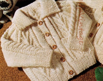 May include: Two knitted cardigans with button closures. One cardigan has a hood and the other has a collar. Both cardigans are cream colored and feature a cable knit pattern.