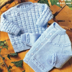 May include: Two knitted baby sweaters in a light blue color. One sweater has a button-up front and the other is a pullover. Both sweaters have a textured stitch pattern. 4 ply, 18-20 ins, 45.5-51 cms.