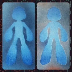 May include: Two blue silhouette stencils of a robot figure on a white background. The stencils are on a textured surface with a grid pattern.