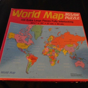 May include: A 300-piece jigsaw puzzle of a colorful world map. The puzzle is 22 inches by 33 inches and features extra large pieces that are fully interlocking.