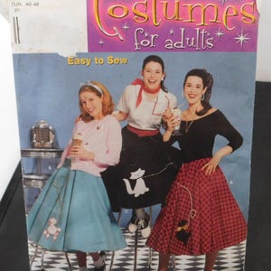 May include: A Simplicity sewing pattern for adults, featuring three women wearing 1950s-style poodle skirts. The pattern number is 5403, size R5, 14-22, EUR 40-48. The pattern is titled "Costumes for adults" and says "Easy to Sew".