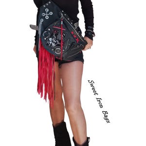 Alternative fashion leather shoulder bag with metal studs and red fringes