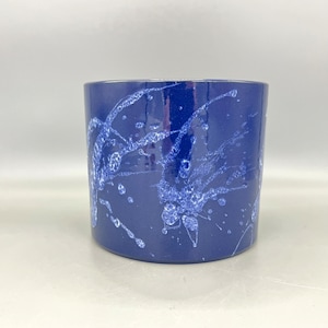 May include: A blue ceramic planter with a white splatter paint design.