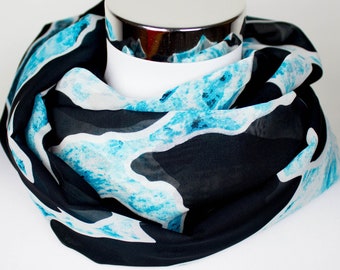 Loop scarf made of chiffon in black with a turquoise wave pattern
