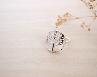 May include: A silver ring with a tree of life design. The ring is made of sterling silver and is a popular choice for those who appreciate nature and symbolism.
