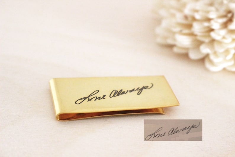May include: A gold-colored money clip with the inscription "Love Always" engraved on the front.