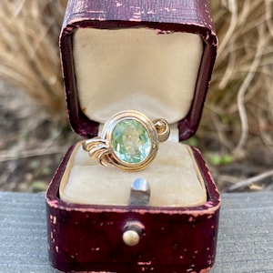 Antique reproduction bezel set glass oval ring in 10k yellow gold