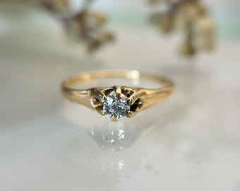 Antique claw-mounted diamond solitaire engagement ring in 14k yellow gold