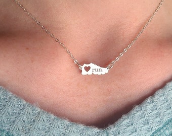 May include: A silver necklace with a shoe charm that says "I love run."