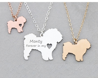 May include: Three silver, gold, and rose gold necklaces with a dog silhouette pendant. The silver pendant has the text "Monty Forever in my heart" engraved on it.