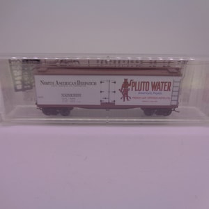 May include: A miniature model of a boxcar with the words "North American Despatch" and "Pluto Water America's Physic French Lick Springs Hotel Co." printed on the side.