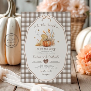 May include: A rectangular baby shower invitation card featuring a brown and white gingham border and a central illustration of a bear with a pumpkin. The text reads A little Pumpkin is on the way, honouring Kaitie and Michael on October 12.