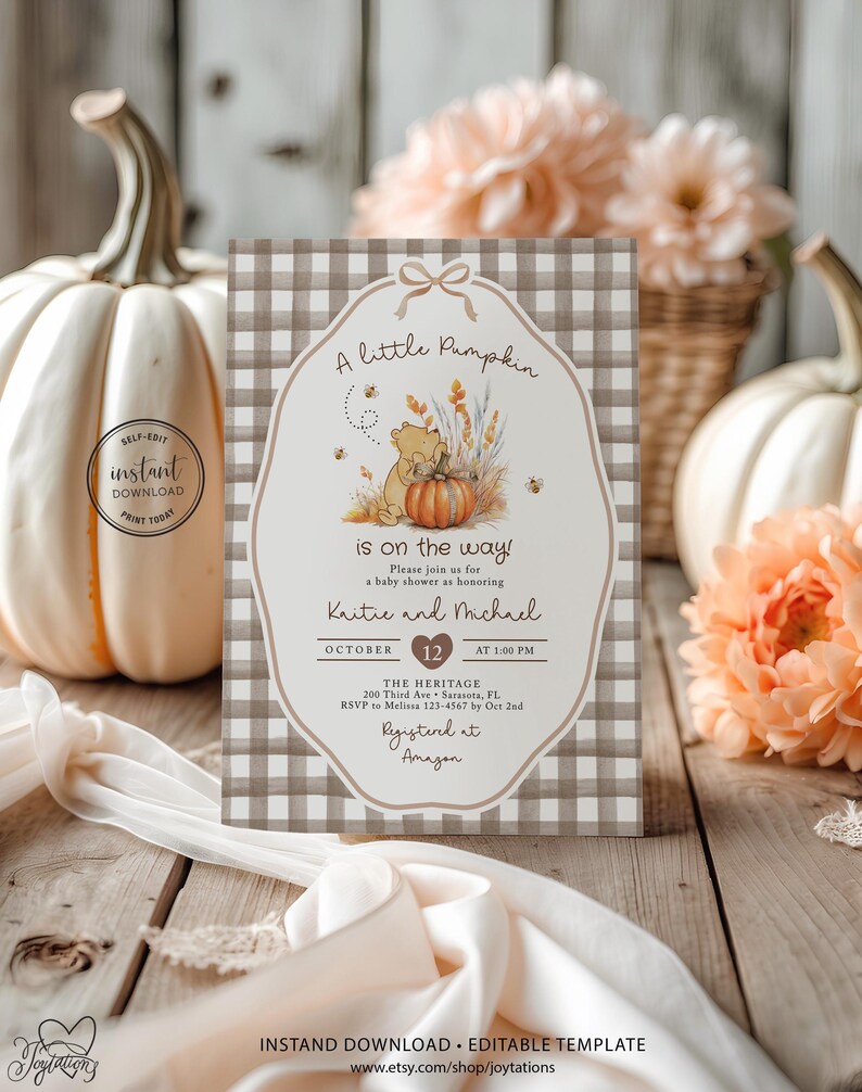 May include: A rectangular baby shower invitation card featuring a brown and white gingham border and a central illustration of a bear with a pumpkin. The text reads A little Pumpkin is on the way, honouring Kaitie and Michael on October 12.