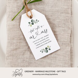 May include: White gift tag with green foliage and the text "first night as mr & mrs" and "You've said "I do", shared hugs & laughter. Now cheers to you both & your happily ever after!"