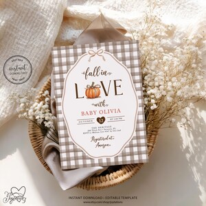 May include: A rectangular baby shower invitation card featuring a brown and white gingham pattern border. The center displays the text fall in LOVE with BABY OLIVIA, an orange pumpkin illustration, date October 12, time 1:00 PM, and event details.