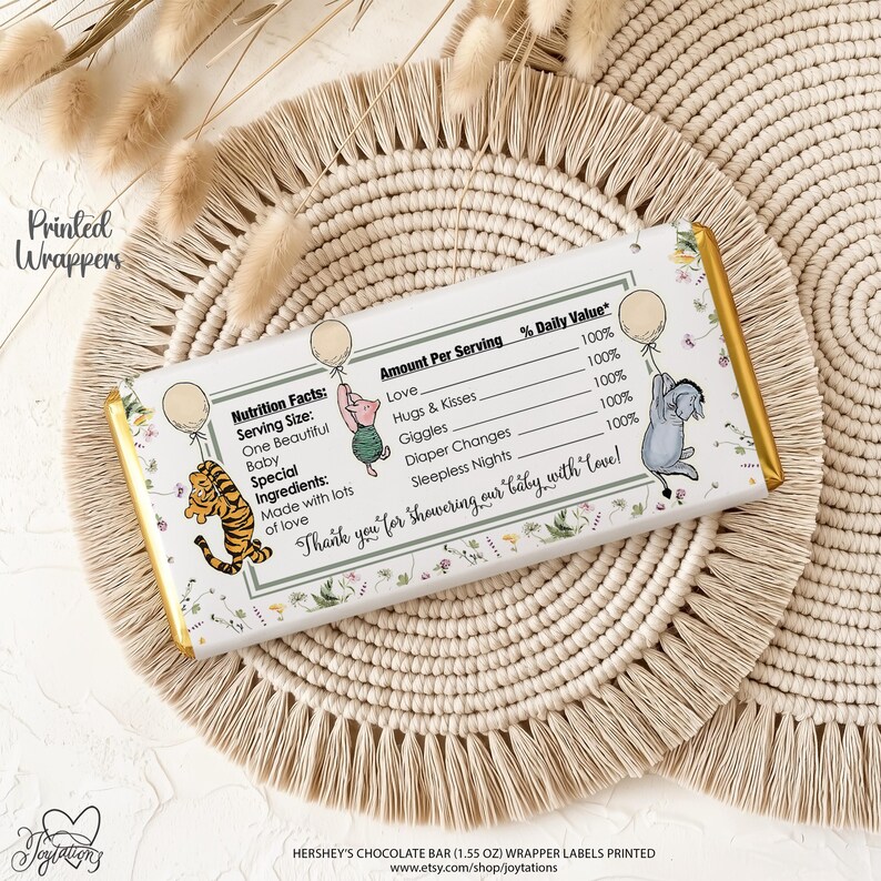 May include: A rectangular chocolate bar wrapper featuring a nutrition facts label with text including Love, Hugs & Kisses, Giggles, Diaper Changes, and Sleepless Nights. Illustrations of a tiger, piglet, and donkey holding balloons are present.