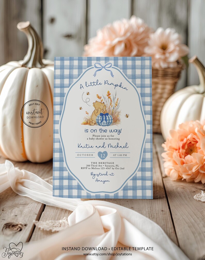 May include: A rectangular baby shower invitation card featuring a light blue and white gingham pattern border. The center displays a cartoon bear, a blue gingham pumpkin, wheat stalks, and bees. Text includes A little Pumpkin is on the way.