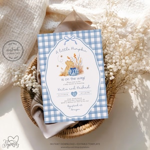 May include: A rectangular baby shower invitation card featuring a light blue and white gingham border. The center displays a cartoon bear, a blue gingham pumpkin, and wheat stalks. Text includes A little Pumpkin is on the way, Kaitie and Michael, October 12, 1:00 PM, The Heritage, 200 Third Ave, Sarasota, FL, RSVP to Melissa 123-4567 by Oct 2nd, and Registered at Amazon.