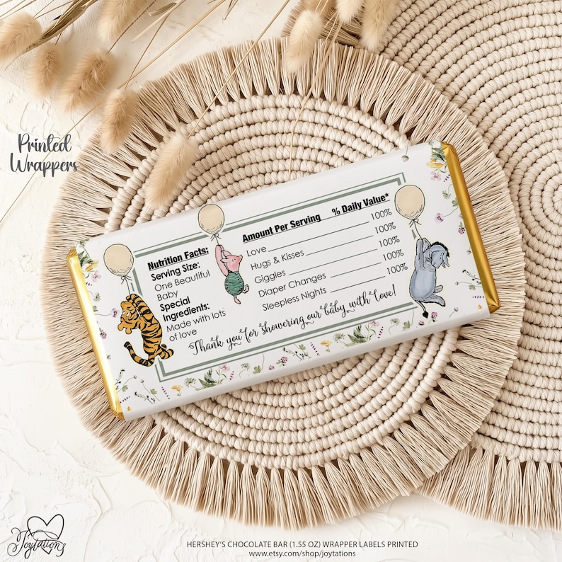 May include: A rectangular chocolate bar wrapper featuring a nutrition facts label with text including Love, Hugs & Kisses, Giggles, Diaper Changes, and Sleepless Nights. Illustrations of a tiger, piglet, and donkey holding balloons are present.