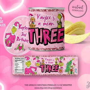 May include: Pink Grinch-themed Pringles can wrapper and lid, with the text "Kaylee's a mean THREE 3rd Birthday". Includes a nutrition label and a banner with Grinch characters. The words "Fits 1.3 OZ Pringles" are also visible.