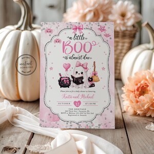 May include: A rectangular baby shower invitation card featuring a pink and white theme with a ghost illustration, a cauldron, a broom, and the text 'a little BOO is almost due'. The design includes pink bows, stars, and bats, with placeholders for names, date, time, and location details.