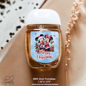 May include: A clear, pocket-sized hand sanitizer bottle with a white cap. The label features Mickey and Minnie Mouse in Christmas attire, with the words "Merry Christmas" on a blue background. The bottle measures 1.25" x 1.375".