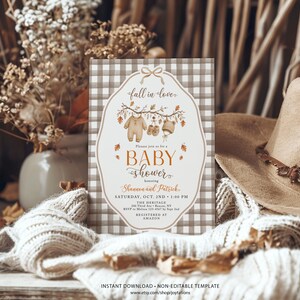 May include: A rectangular baby shower invitation card with a brown and white gingham border. The center features a white label shape with a bow, autumn leaves, and baby clothes illustrations. Text includes fall in love, baby shower, Shannon and Patrick, Saturday, Oct. 2nd, 1:00 PM, The Heritage, 100 Third Ave, Beacon, NY, RSVP to Melissa 123-4567 by Sept 2nd, and Registered at Amazon.
