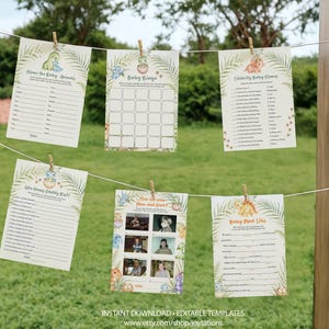May include: Six rectangular baby shower game cards hanging on a string with wooden clips. The cards feature illustrations of cartoon dinosaurs and tropical leaves, with printed text including Name the Baby Animals, Baby Bingo, and Celebrity Baby Names.